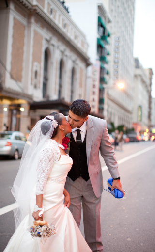 a bride and groom kissing outside the marker
