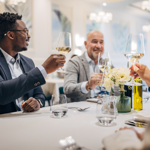a group of people toasting at the marker
