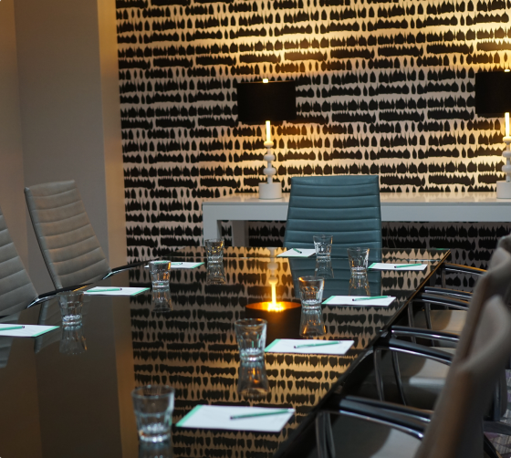 a meeting venue with a table and chairs at the marker