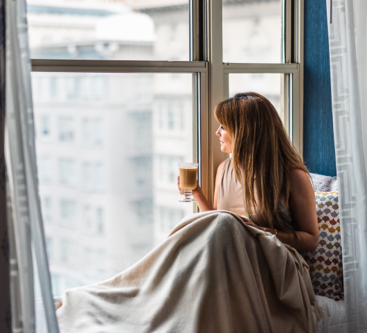 woman looking out a window while stayin at the marker