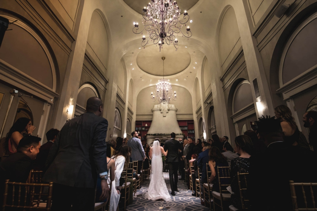 A bride and groom walking down the isle during their wedding at The Marker