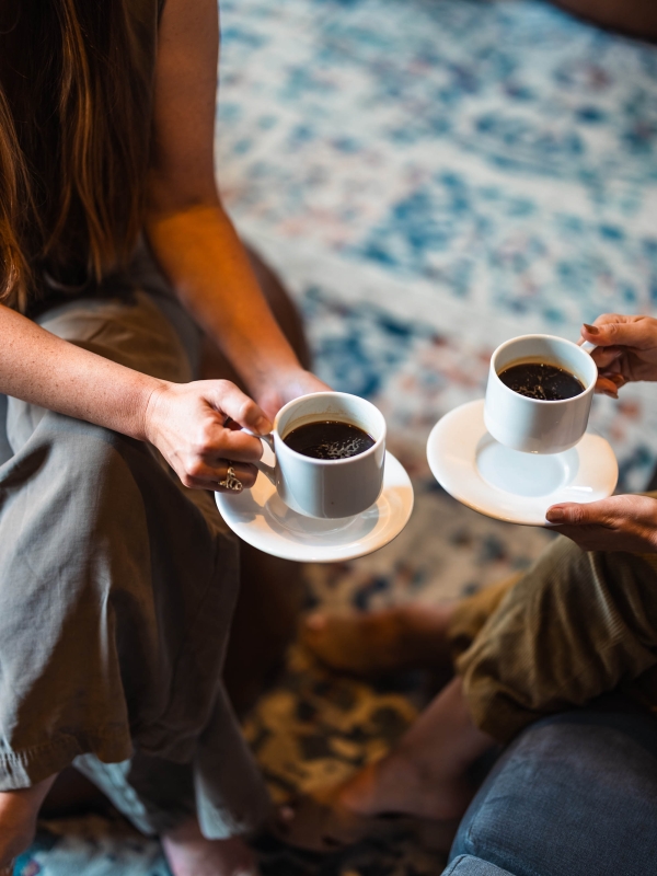 Two people enjoying cups of coffee at The Marker