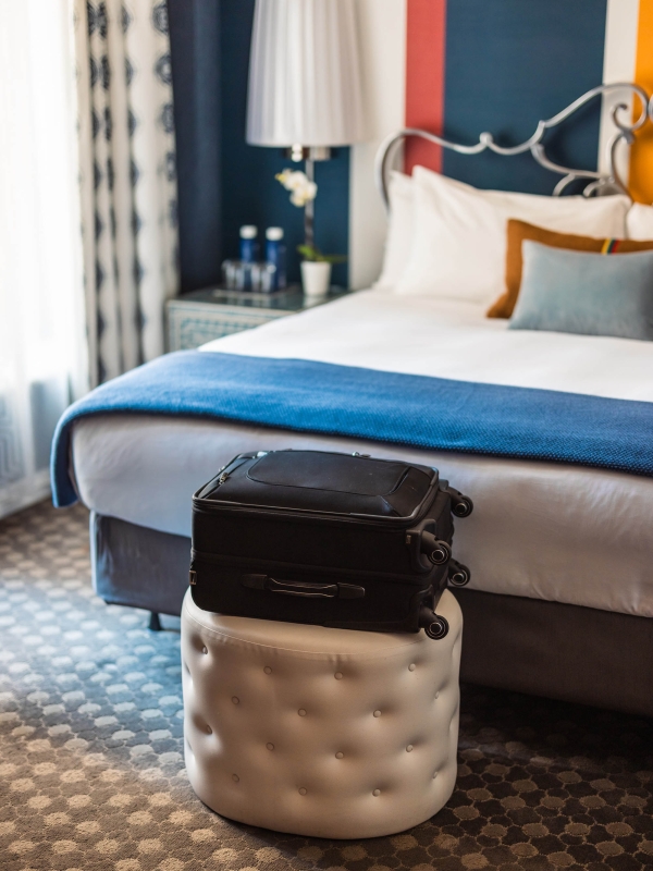 Luggage sitting on a stool in a bedroom at The Marker