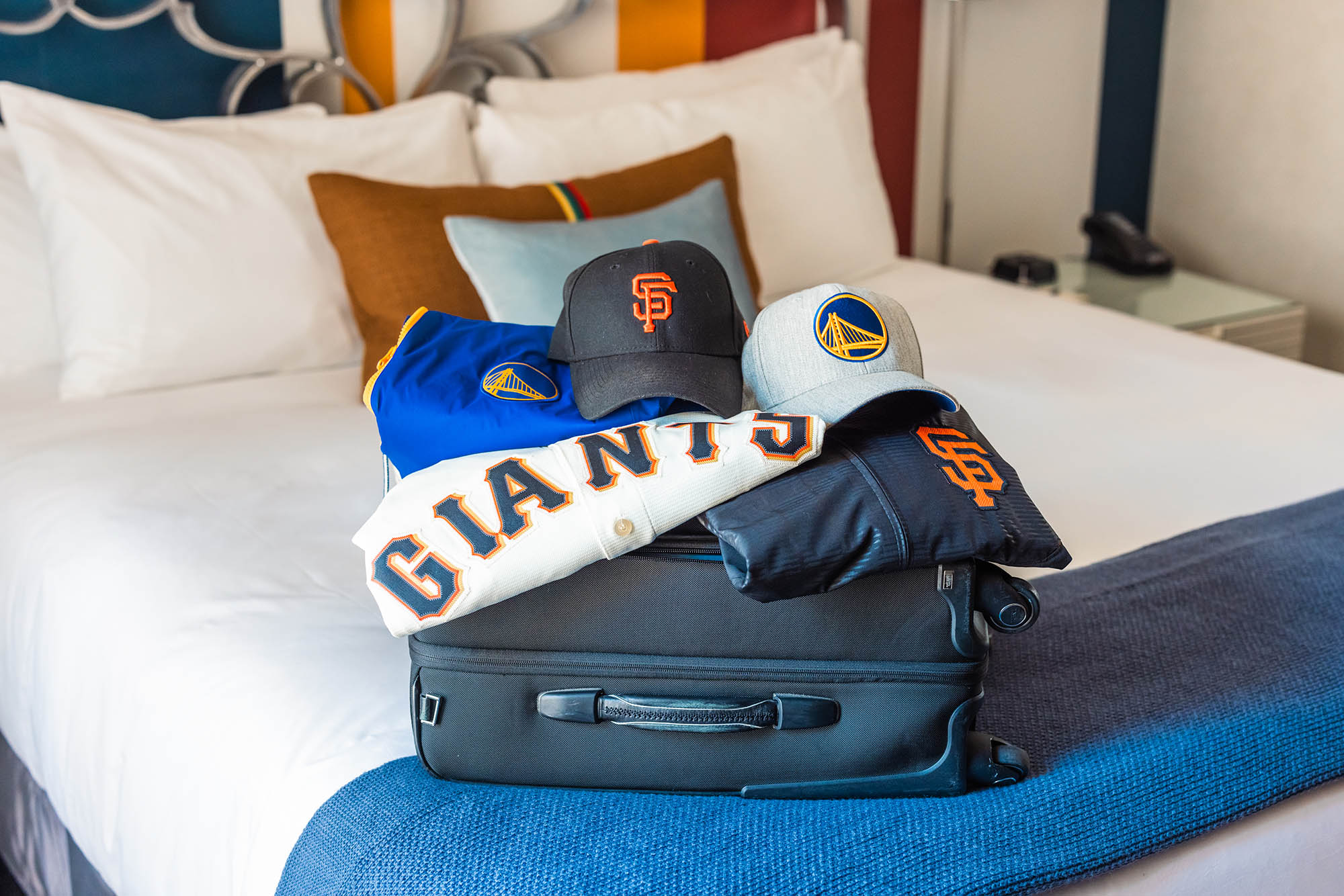 San Francisco sports teams merchandise sitting on luggage at The Marker