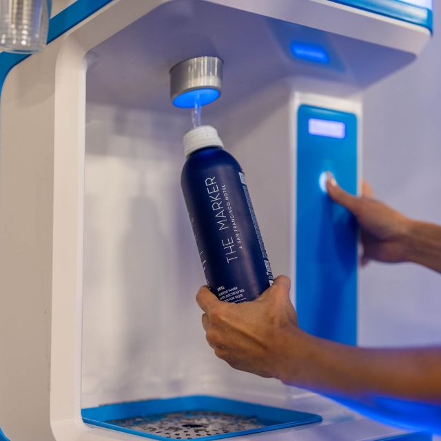 A woman filling up a water bottle at The Marker