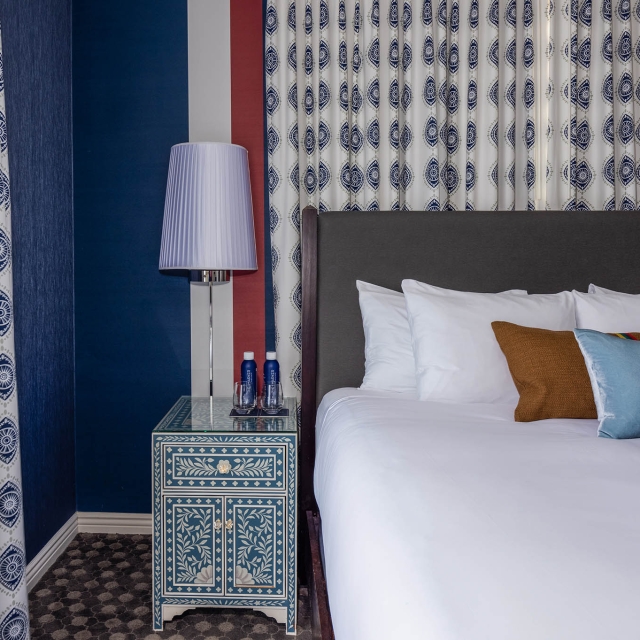 A nightstand sitting next to a bed at The Marker